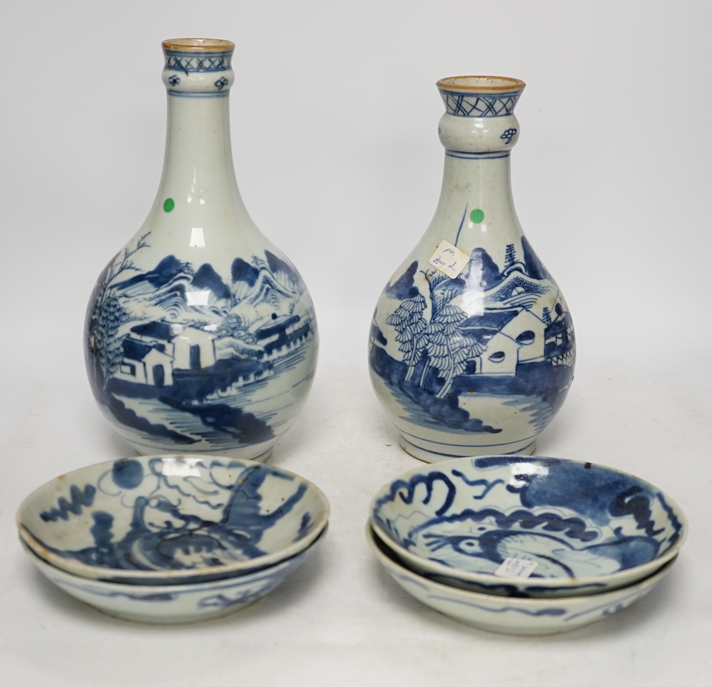 Two 18th century Chinese blue and white guglet bottles and four 19th century Chinese blue and white 'dragon' dishes, tallest 25cm. Condition - fair